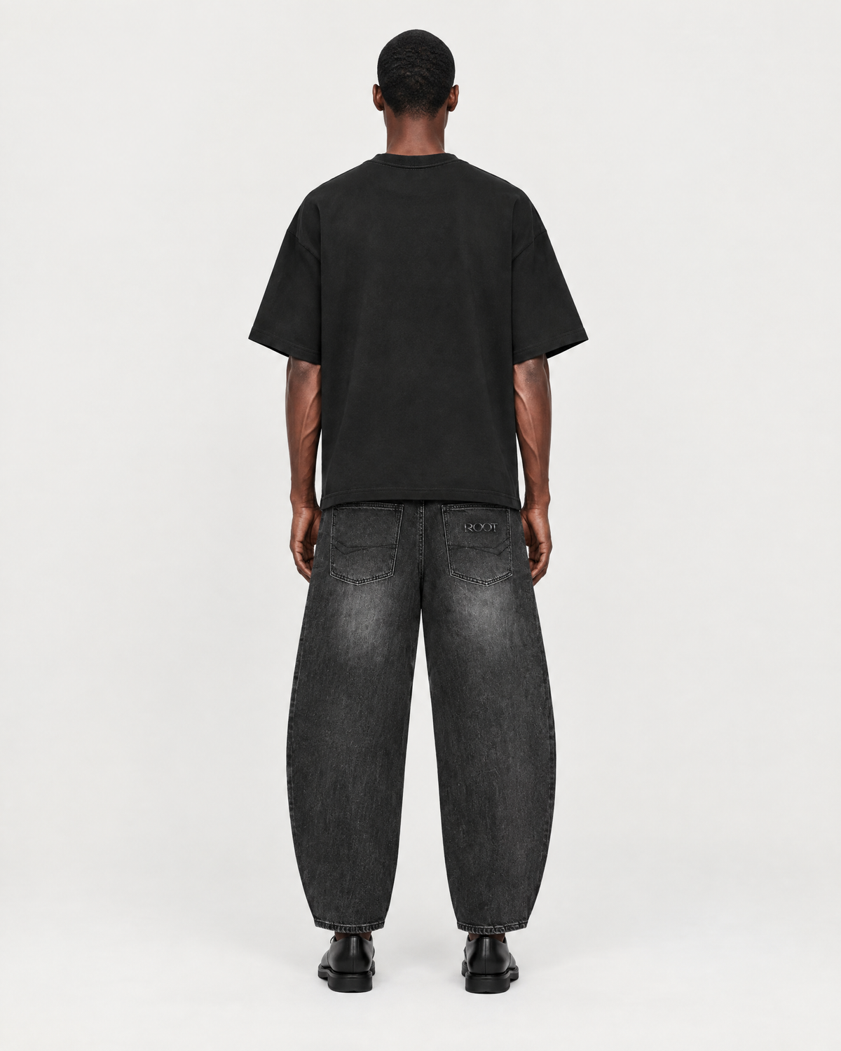Sunfade Barrel Jean in Black, on model back, worn by a man
